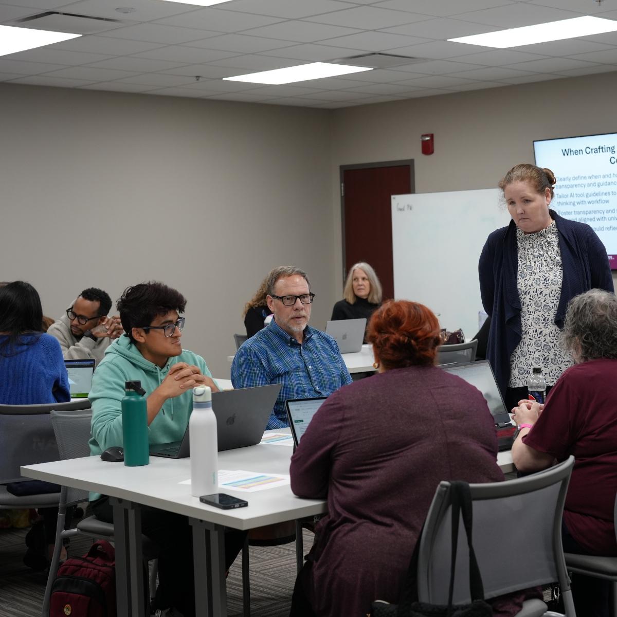 Nicole Miller, CITE Faculty Fellow, interacting with faculty at an AI workshop..